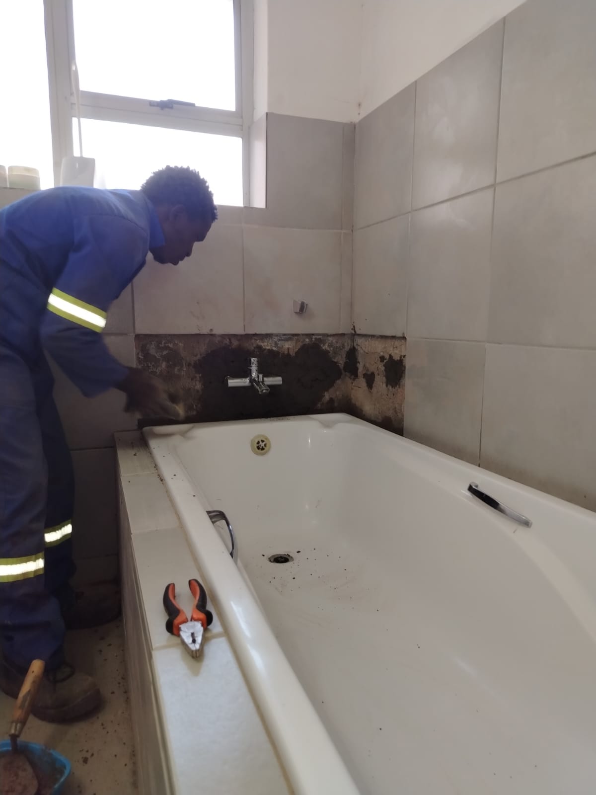 Bathusi technician inspecting a plumbing system